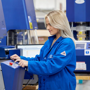 A woman working with a Premier RPA Instrument from Alpha Technologies