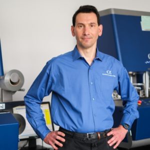 A person standing in a lab with his hands on his hips